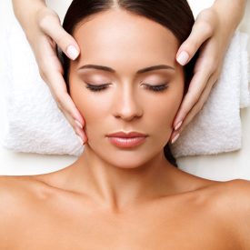 Face Massage. Close-up of a Young Woman Getting Spa Treatment.